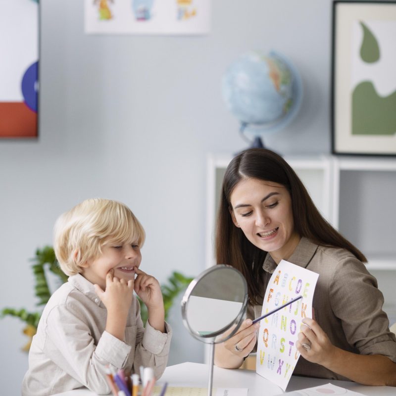 woman-doing-speech-therapy-with-little-boy-her-clinic